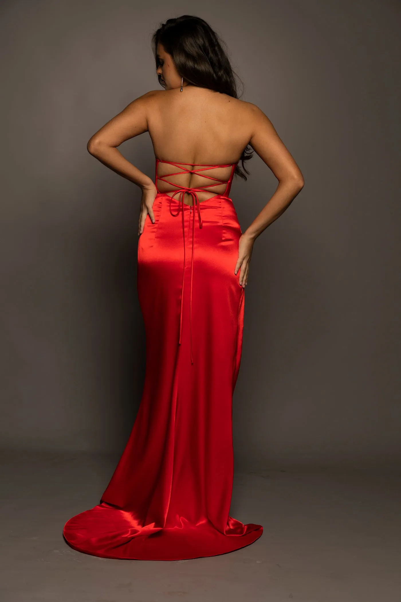 Bright red satin dress with wavy neckline and ruching high slit